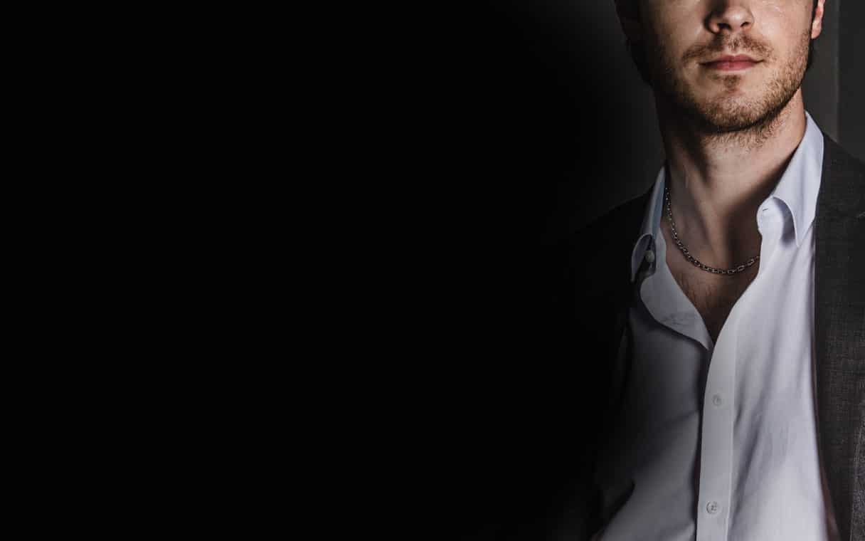 A 6mm men's platinum cable chain necklace wearing on a male model in formal suit